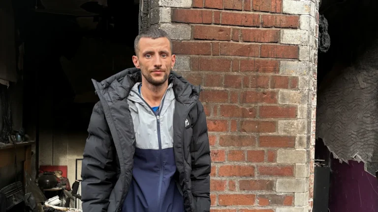 A destroyed home in Belfast after disorder, with a community coming together to support those affected, highlighting the importance of community and the need for support in times of need, with a focus on the primary keyword of Belfast disorder