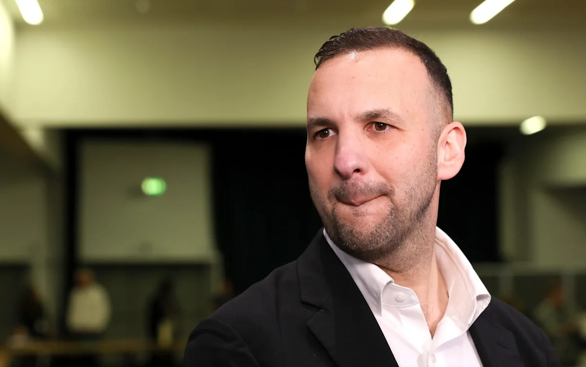 A group of green activists holding a banner with a slogan, with a red X marked through it, symbolising the rejection of anti-Semitic behaviour and the promotion of inclusivity and respect for all individuals, regardless of their background or faith, in the context of environmentalism and social justice