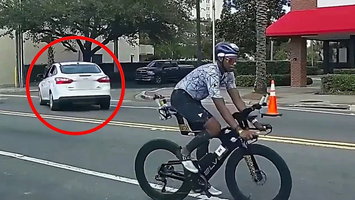 Officers pursuing a driver through an active Ironman race in Florida, with athletes and spectators looking on in concern, highlighting the need for increased security measures at public events like the Ironman race