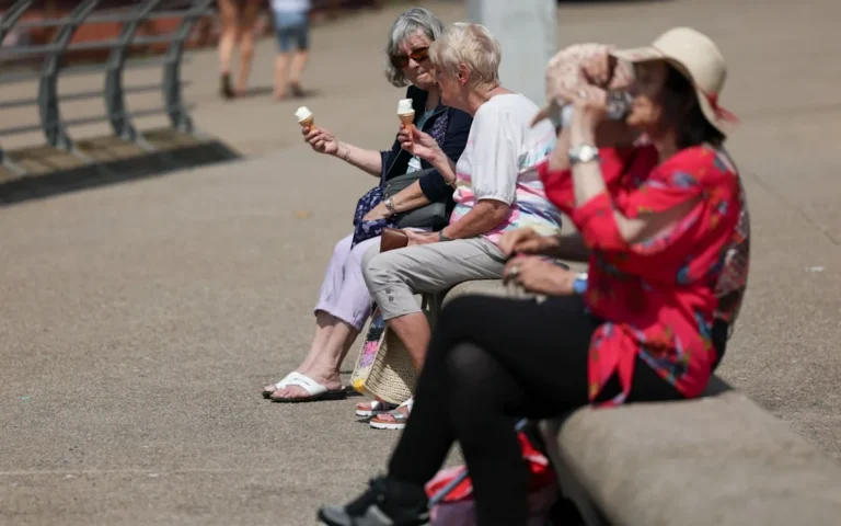 A descriptive image of a sunny day in Britain, with clear blue skies and warm temperatures, highlighting the June heatwave that will bring Britain's temperature higher than Barbados