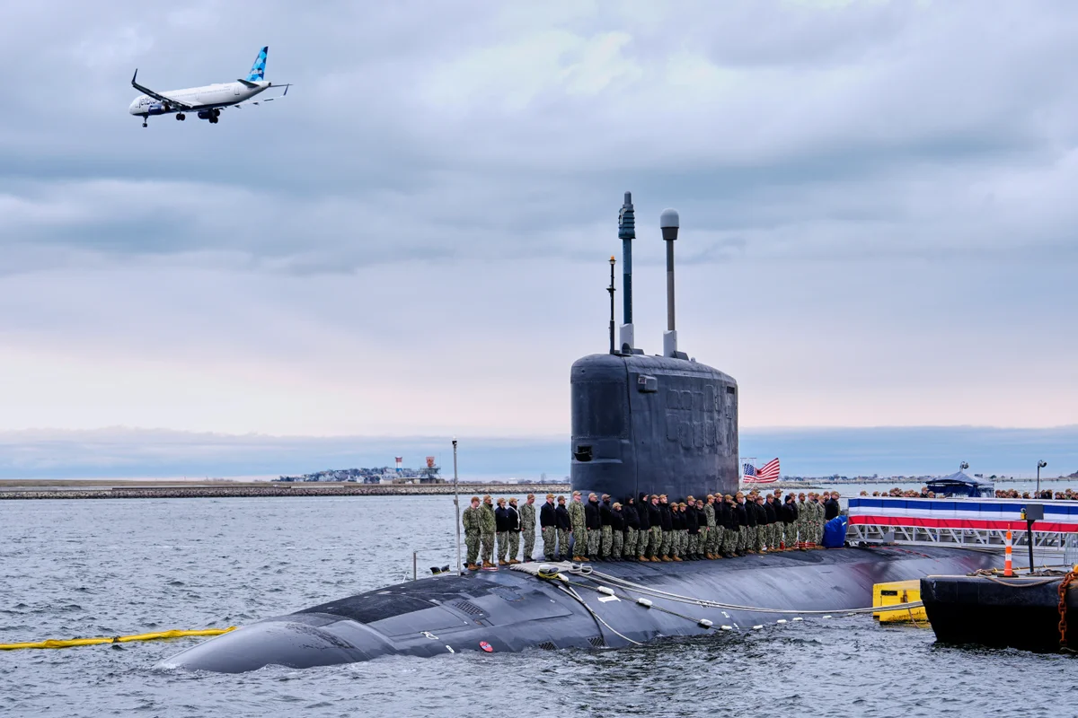 The USS Massachusetts submarine sailing through open waters, with a Tomahawk cruise missile on display, showcasing its impressive capabilities and advanced technology, highlighting its significance in the Navy fleet and its role in enhancing national security