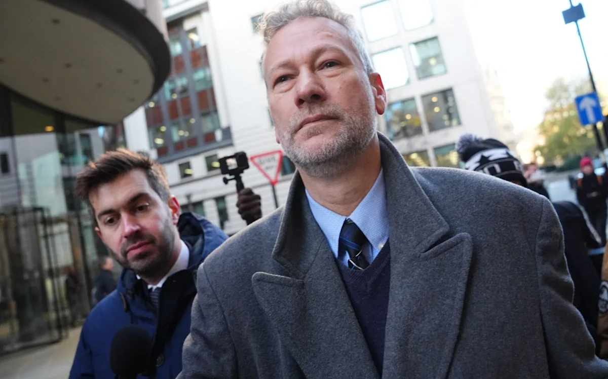 A person holding a British passport, with a blurred background of the UK flag, symbolising the complex issue of expat donations and human rights, with the Labour Party's reform efforts at the forefront