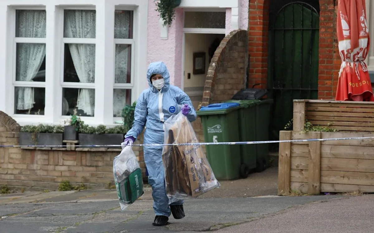 A forensic expert analysing the scene outside the home where an elderly woman was stabbed to death, with police tape and officers in the background, highlighting the importance of community vigilance and safety measures for elderly individuals