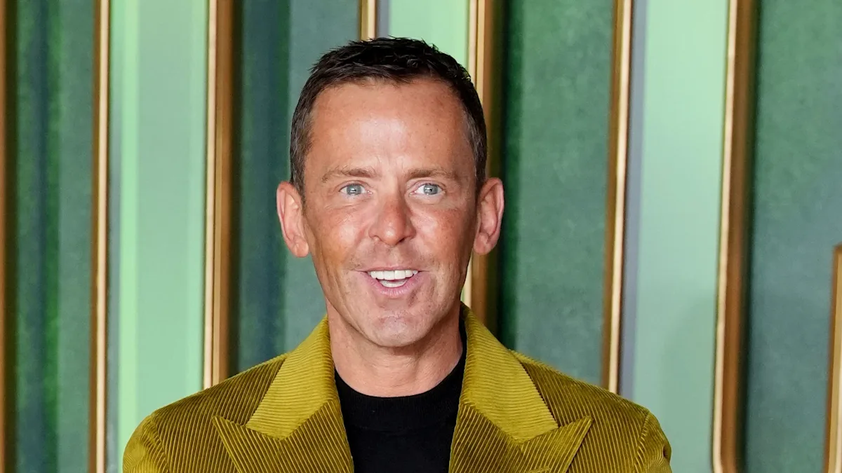 Scott Mills, a renowned radio presenter, poses for a photo amidst rumours and speculation surrounding his BBC departure, highlighting the challenges faced by the entertainment industry