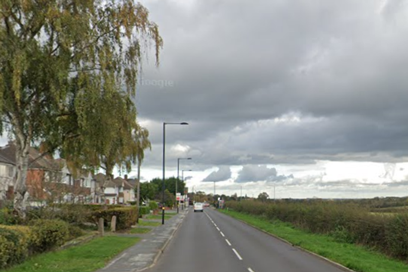 A photo of a bus in Sutton Coldfield with a blurred background, highlighting the importance of bus safety and security measures, including CCTV cameras and on-board security systems, with the primary keyword bus safety