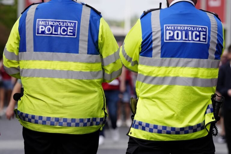 Met Police officers in uniform with Freemasons logo